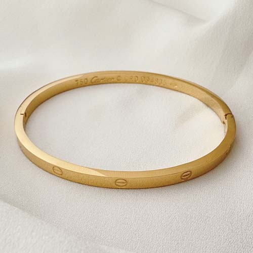 دستبند کارتیه لاو استیل مدل گرد طلایی نازک